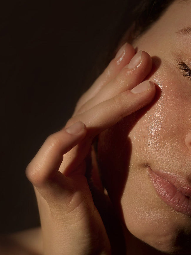 Woman stroking her face