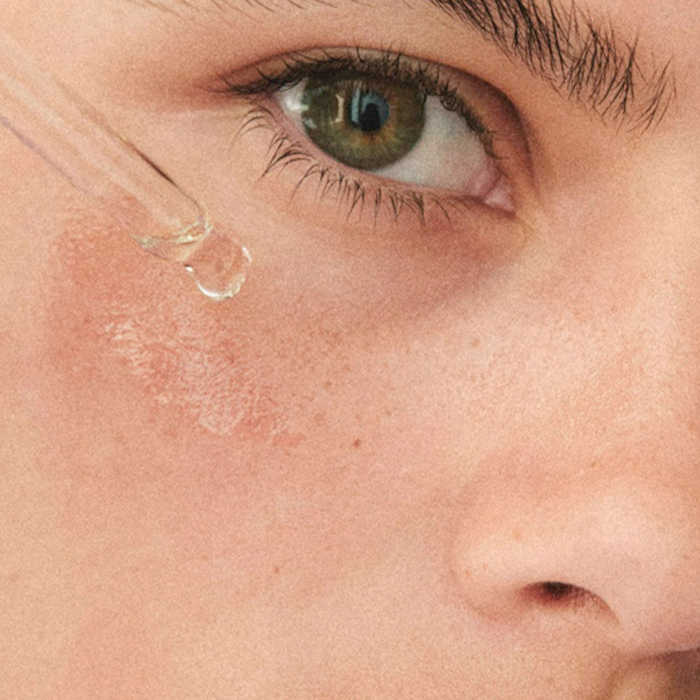 drops A serum is applied to a woman's cheek, close to her eye.