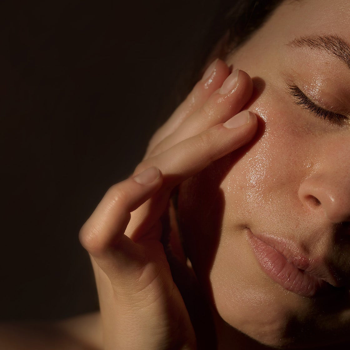 Woman stroking her face